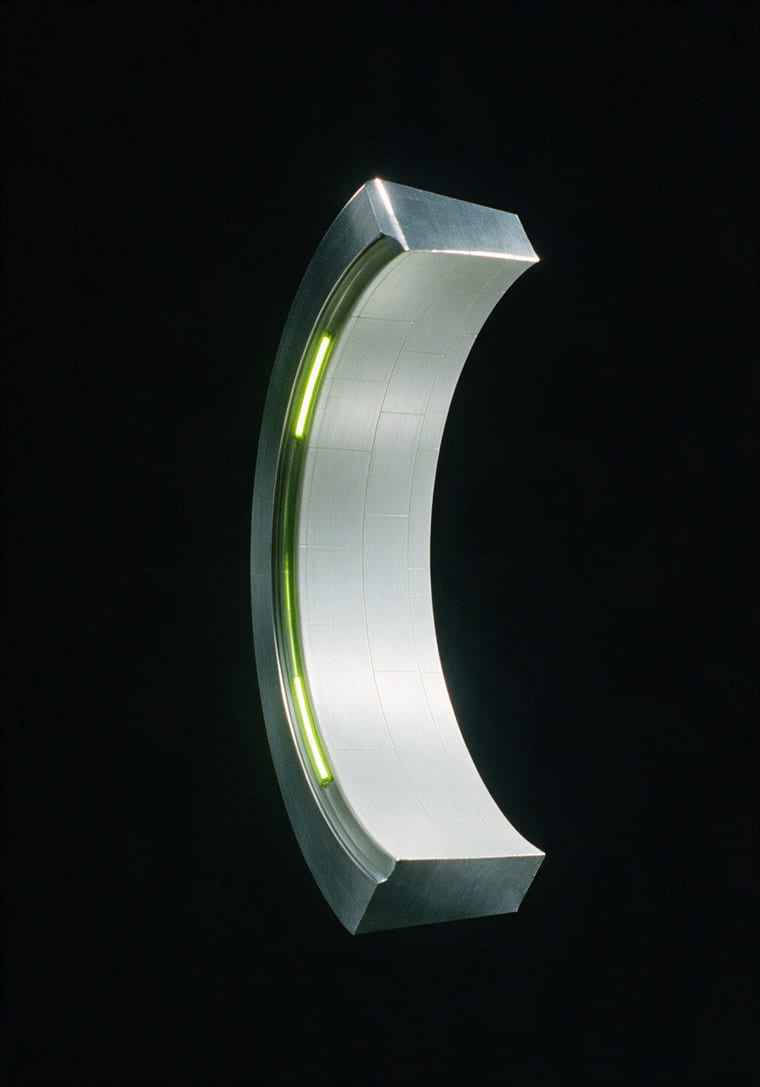 A curved segment of a machined orbital ring with a lime light strip, on black